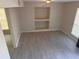 Living room with gray tile floors and built-in shelving unit at 1168 Dogwood Nw Ct, Conyers, GA 30012