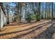 Partially wooded backyard with shed at 125 Clayton St, Fairburn, GA 30213