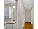 Hallway view of well-lit bathroom featuring a granite vanity and white fixtures, enhancing the home's aesthetic at 1094 Old Roswell Rd, Roswell, GA 30076