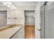 Bright bathroom with a granite countertop, white cabinets, and a glass-enclosed shower with modern fixtures at 1094 Old Roswell Rd, Roswell, GA 30076