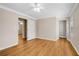 Bright bedroom featuring neutral walls, wood floors, and a walk-in closet with ample storage space at 1094 Old Roswell Rd, Roswell, GA 30076