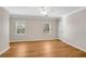 Bright bedroom with neutral walls, white trim, and wood floors, offering a serene retreat at 1094 Old Roswell Rd, Roswell, GA 30076