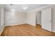 Bedroom featuring neutral decor, wood flooring, ceiling fan, and multiple entrances for convenience at 1094 Old Roswell Rd, Roswell, GA 30076