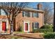 Beautiful brick townhouse with a well-maintained lawn and a vibrant red front door at 1094 Old Roswell Rd, Roswell, GA 30076