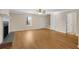 Open-concept living room featuring light wood floors, a fireplace, and natural light at 1094 Old Roswell Rd, Roswell, GA 30076