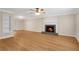 Spacious living room with a fireplace, ceiling fan, and laminate wood flooring at 1094 Old Roswell Rd, Roswell, GA 30076