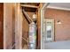 Water heater inside an unfinished utility room with brick wall and access to a patio at 1094 Old Roswell Rd, Roswell, GA 30076