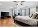 Bright bedroom featuring hardwood floors and a large TV at 2344 Saint Davids Nw Sq # 2, Kennesaw, GA 30152