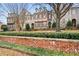 Townhome complex with a brick wall and neatly trimmed shrubs at 2344 Saint Davids Nw Sq # 2, Kennesaw, GA 30152