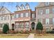 Three-story brick townhome with stone accents and shutters at 2344 Saint Davids Nw Sq # 2, Kennesaw, GA 30152