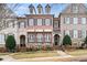 Brick three-story townhome with shutters, balconies, and a manicured lawn at 2344 Saint Davids Nw Sq # 2, Kennesaw, GA 30152