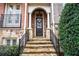 Charming front entry with stone steps and dark brown door at 2344 Saint Davids Nw Sq # 2, Kennesaw, GA 30152