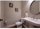 Elegant powder room with pedestal sink and decorative mirror at 2344 Saint Davids Nw Sq # 2, Kennesaw, GA 30152