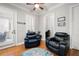 Relaxing sitting room with two leather armchairs, hardwood floors, and access to a patio at 2344 Saint Davids Nw Sq # 2, Kennesaw, GA 30152