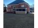 Rear view of house showing screened porch and yard at 240 Flowers Cove Ln, Lilburn, GA 30047