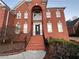 Brick house with a large entryway and staircase at 240 Flowers Cove Ln, Lilburn, GA 30047