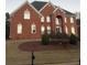 Brick house with a two-car garage and manicured lawn at 240 Flowers Cove Ln, Lilburn, GA 30047