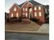 Brick two-story house with a large front yard and driveway at 240 Flowers Cove Ln, Lilburn, GA 30047