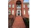 Brick house entrance with steps leading to a dark brown door and arched windows at 240 Flowers Cove Ln, Lilburn, GA 30047