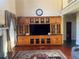 Living room with built-in entertainment center and hardwood floors at 240 Flowers Cove Ln, Lilburn, GA 30047