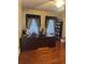 Home office with hardwood floors, large desk, and built-in shelves at 240 Flowers Cove Ln, Lilburn, GA 30047