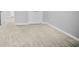 Spacious carpeted basement with neutral walls and double doors at 4115 Brightmore Dr, Austell, GA 30106