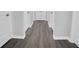 Hallway with dark gray vinyl plank flooring and white doors at 4115 Brightmore Dr, Austell, GA 30106