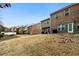 Row of townhomes showcasing a shared grassy backyard area at 11112 Benton Woods Dr, Covington, GA 30014