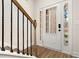 Bright entryway with wooden staircase and iron railing at 11112 Benton Woods Dr, Covington, GA 30014