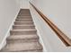 Carpeted staircase with wooden handrail at 12 Flower Petal Way, Dacula, GA 30019