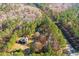 Aerial view showing house, detached garage, and wooded lot at 247 Island Shoals Rd, Covington, GA 30016