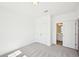 This bedroom features neutral carpet, a double door closet, and an attached bathroom at 7293 Eton Ln, Locust Grove, GA 30248
