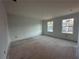 Unfinished bedroom with two windows and drywall at 7293 Eton Ln, Locust Grove, GA 30248