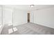 Upstairs bedroom with gray carpet, crisp white walls, and two windows for natural light at 7293 Eton Ln, Locust Grove, GA 30248