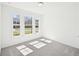 Bright bedroom with neutral carpet and three large windows, offering ample natural light at 7293 Eton Ln, Locust Grove, GA 30248