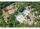 Aerial image showcasing community amenities, including tennis courts, pools, water slides, and recreational areas amidst green surroundings at 7293 Eton Ln, Locust Grove, GA 30248