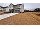 Charming two-story home with gray siding and shutters, a two car garage and expansive front lawn at 7293 Eton Ln, Locust Grove, GA 30248