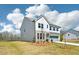 Two-story home showcasing modern design, well-maintained lawn, and long driveway with ample space at 7293 Eton Ln, Locust Grove, GA 30248