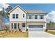 Charming two-story home with stone accents, manicured lawn, and a spacious two-car garage at 7293 Eton Ln, Locust Grove, GA 30248