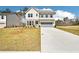 A charming two-story house with a clean front lawn, long driveway and a two-car garage at 7293 Eton Ln, Locust Grove, GA 30248