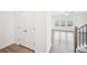 Hallway view featuring hardwood floors, closet, and entryway to living room at 7293 Eton Ln, Locust Grove, GA 30248