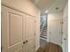 Hallway view with closet, wooden floors, and stairs leading up to the second floor at 7293 Eton Ln, Locust Grove, GA 30248