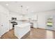 Modern kitchen with white cabinets, stainless steel appliances, and a large center island at 7293 Eton Ln, Locust Grove, GA 30248