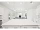Bright kitchen island looking out to living room with fireplace and stairs at 7293 Eton Ln, Locust Grove, GA 30248