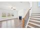 Inviting living room with fireplace, large windows and an adjacent staircase at 7293 Eton Ln, Locust Grove, GA 30248