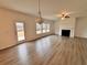 Bright living room with fireplace, large windows, and wood-look flooring at 7293 Eton Ln, Locust Grove, GA 30248