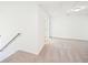 The upstairs loft is spacious with plush neutral carpet and bright white walls at 7293 Eton Ln, Locust Grove, GA 30248
