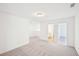 Upstairs loft with plush gray carpet, light gray walls, and access to the bathroom and bedroom at 7293 Eton Ln, Locust Grove, GA 30248