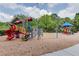 A vibrant community playground with slides, climbing structures, and a soft landing surface at 7293 Eton Ln, Locust Grove, GA 30248