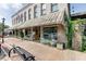 Storefront with striped awning, outdoor seating, and large display windows, inviting customers into the commercial space at 7293 Eton Ln, Locust Grove, GA 30248